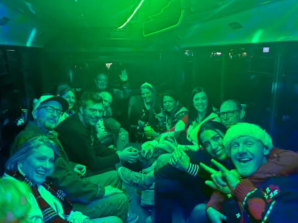 A group under green LED lights along the 16's side seating