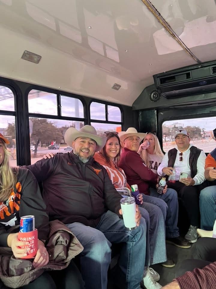 A crew in burnt orange and cowboy hats on board the 16